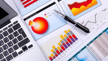 Financial paper charts and graphs on the table