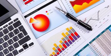 Financial paper charts and graphs on the table