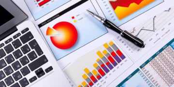 Financial paper charts and graphs on the table